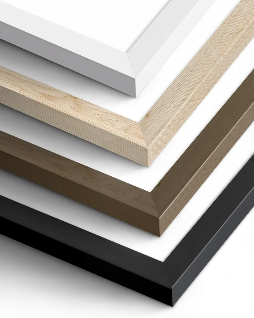 A collection of picture frames in various finishes. The top frame is white, followed by light wood, a brown wood finish, and a black frame, all featuring clean, modern lines suitable for different decor styles.