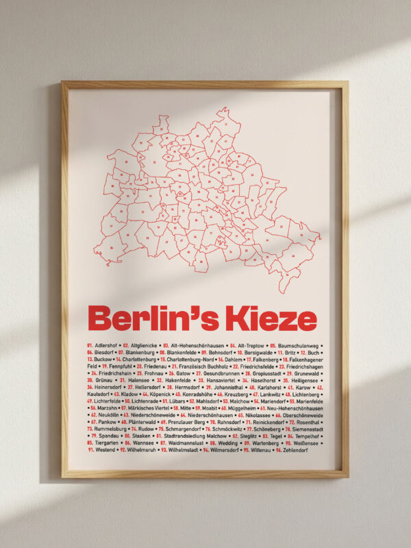 The Berlin Kieze Map Poster features an illustrated map of all neighborhoods of Berlin in red on a light background, framed in a simple gold frame, providing a clear visual representation of the city's districts.