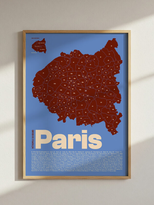The Paris Departments and Communes of Grand Paris Map Poster features a red map design on a blue background, framed in a light wood frame. The poster prominently displays the word 'Paris' in large white letters, providing a modern artistic representation.