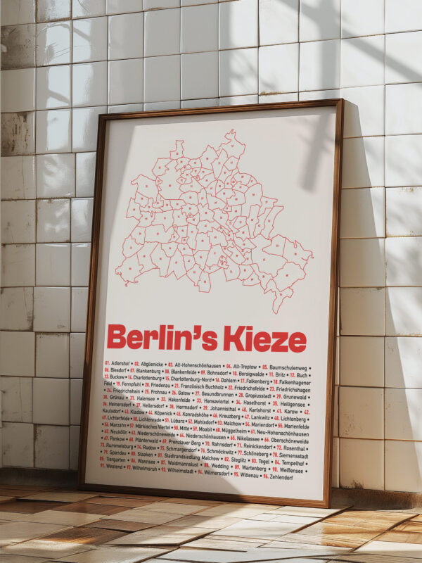 The Berlin Kieze Map Poster features an illustration of all neighborhoods in Berlin, with a prominent 'Berlin Kieze' title in bold red typography. The poster is presented in a light wooden frame, suitable for wall display.