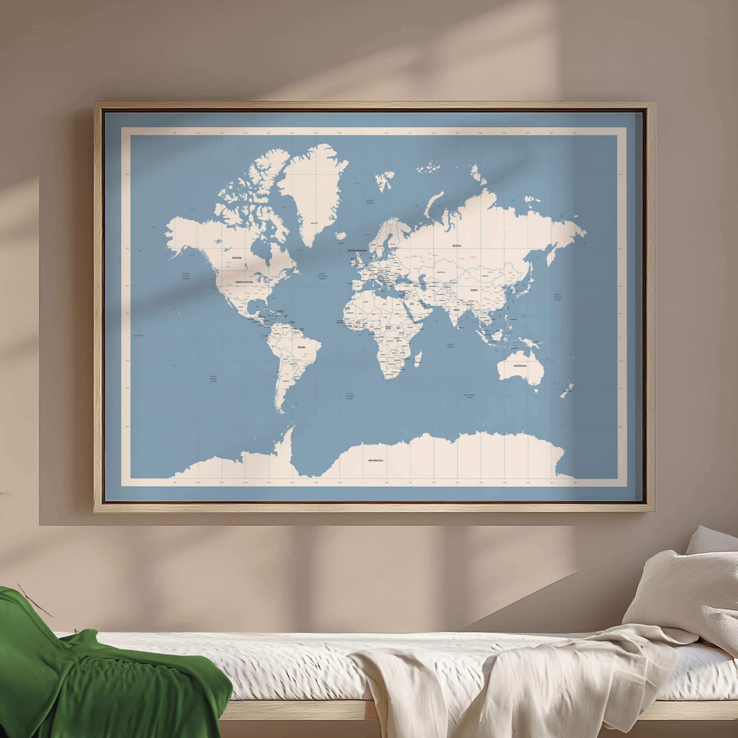 Framed blue and white world map hanging above bed in modern bedroom