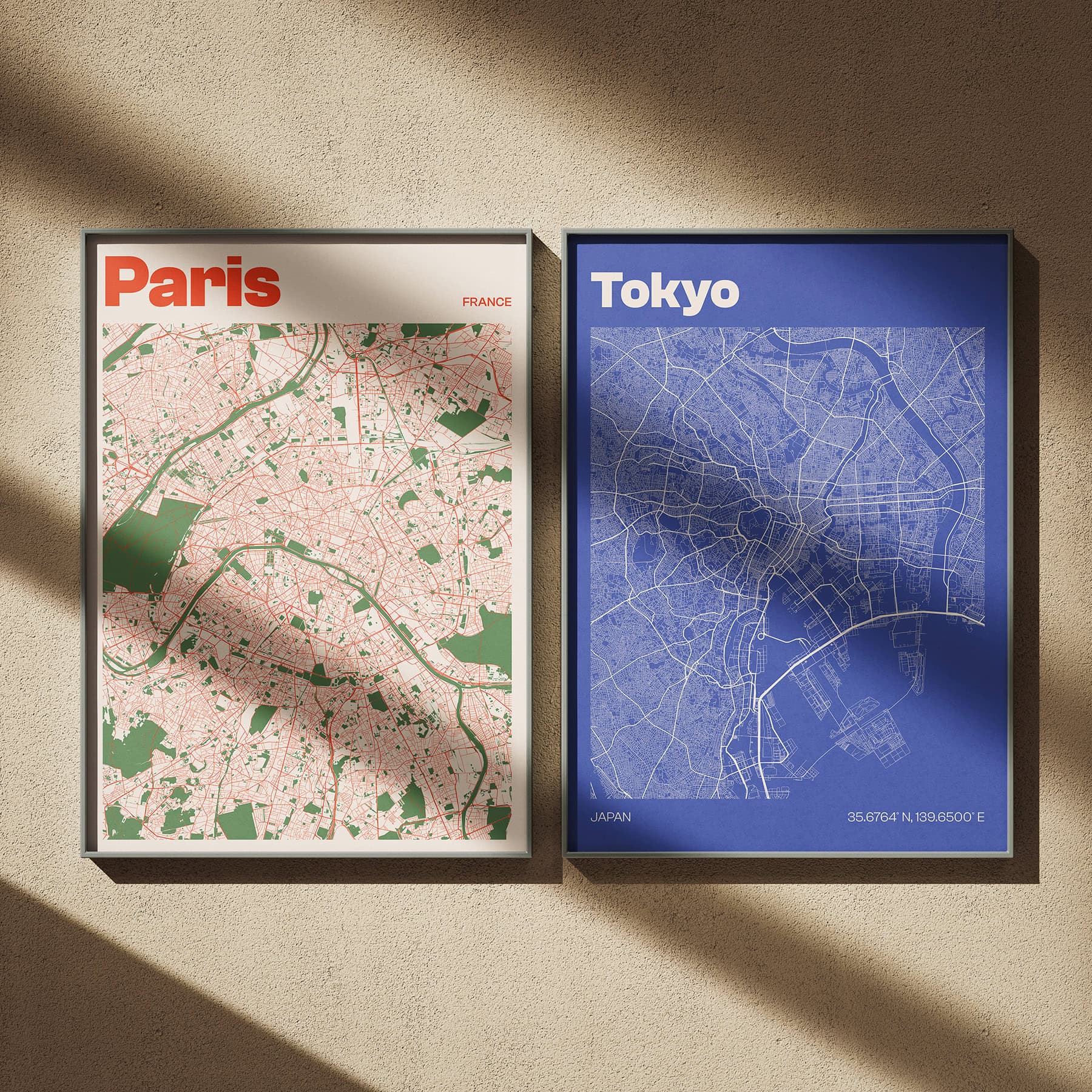 Two framed city map prints of Paris and Tokyo hanging on wall