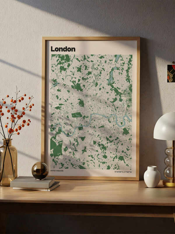 A framed map of London hangs on a wall, showcasing a detailed layout with green parks. A decorative vase with orange berries and a modern lamp are placed on a wooden desk, enhancing the contemporary interior design.